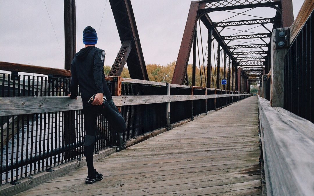Runner stretching on bridge